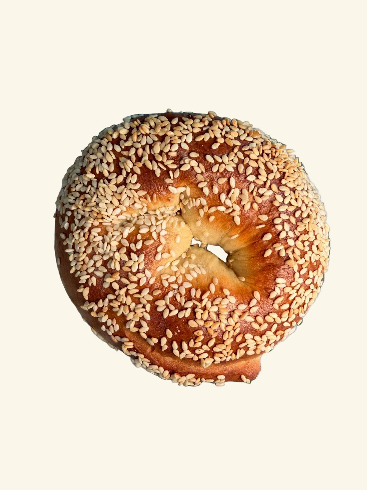 Sesame seed bagel on a green and white checkered background